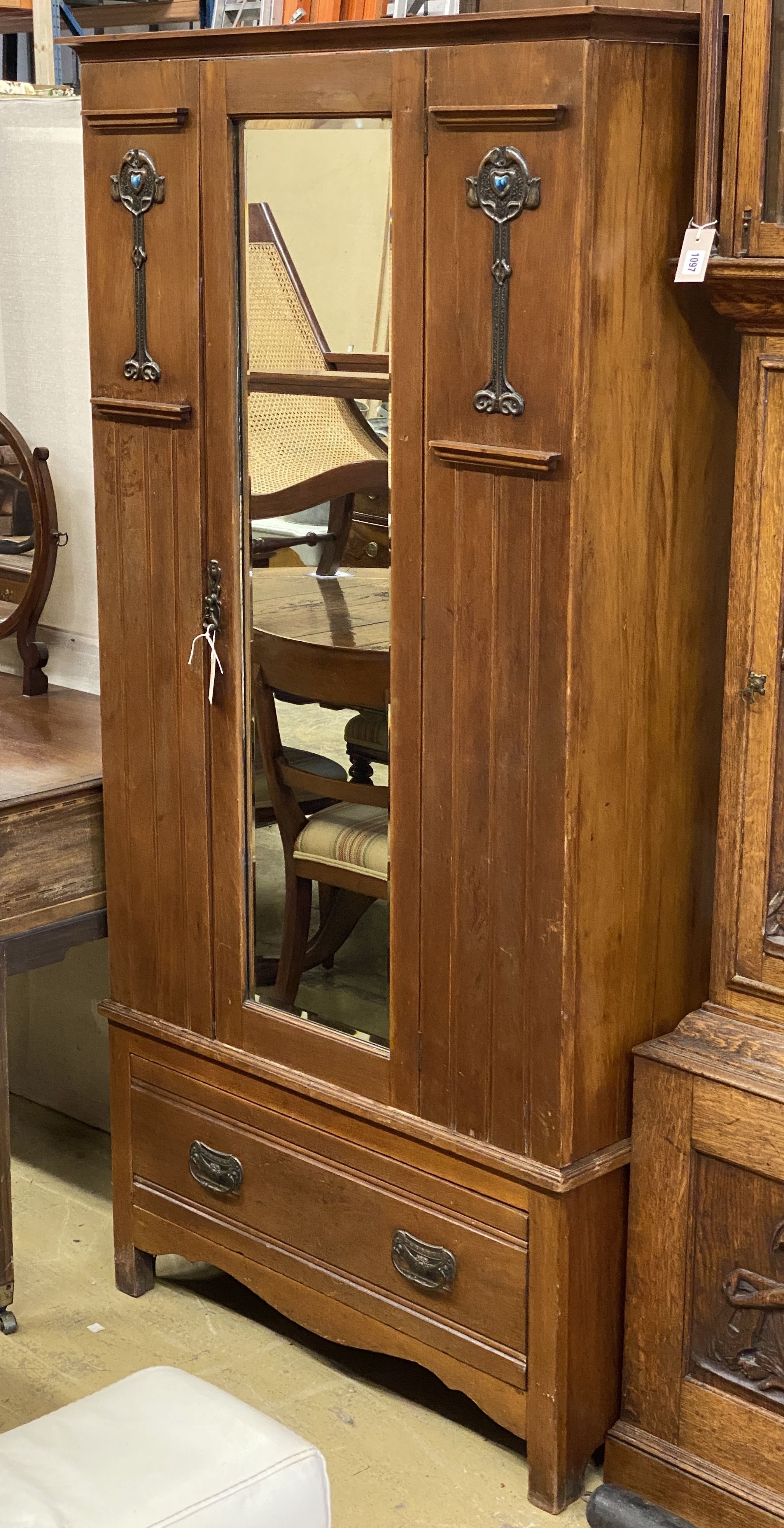 An early 20th century Arts & Crafts mirrored walnut wardrobe, length 96cm, depth 39cm, height 188cm